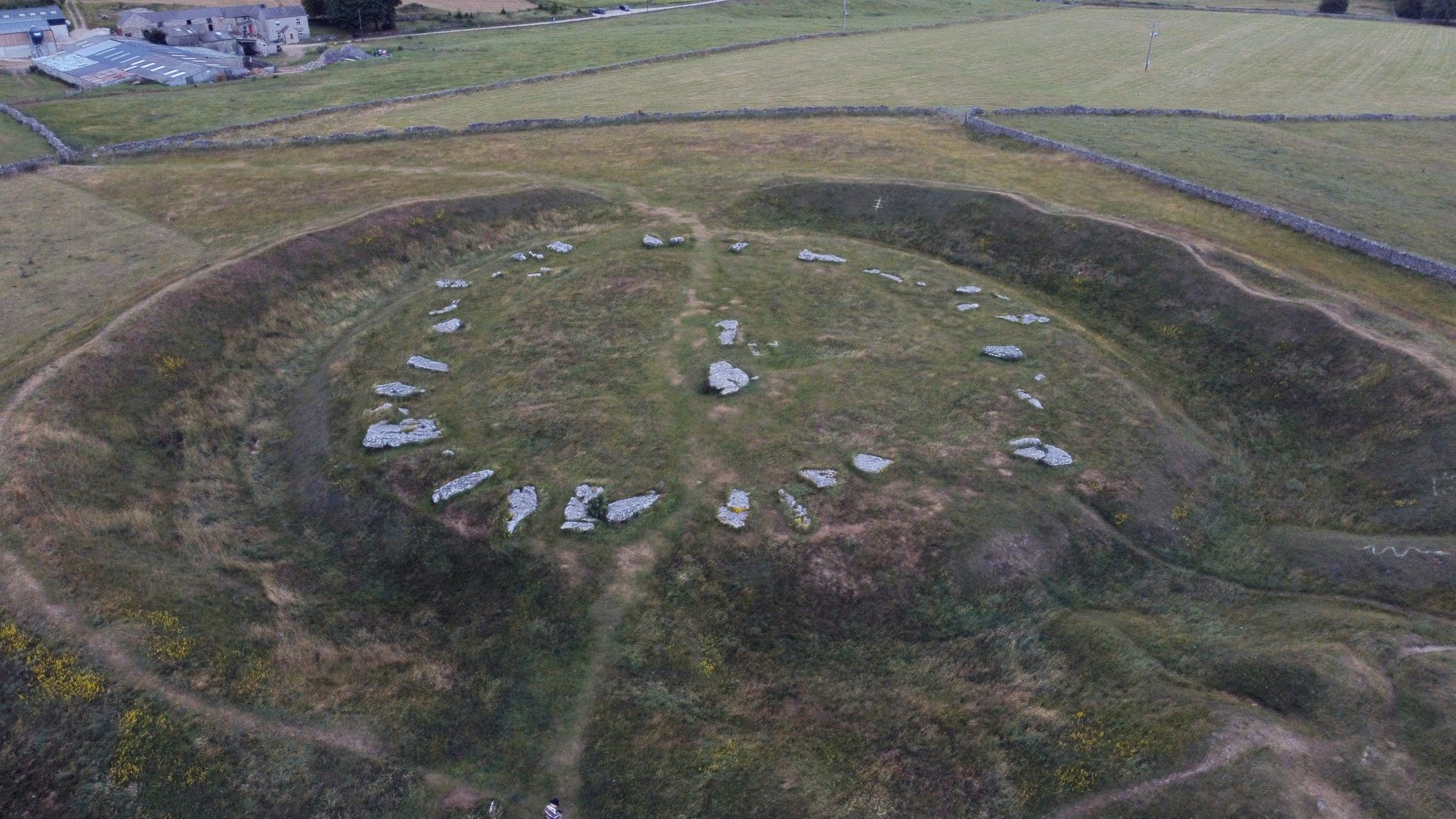 Arbor Low from above. The bank and ditch enclose fallen limestone slabs; the monument developed through more than one phase.